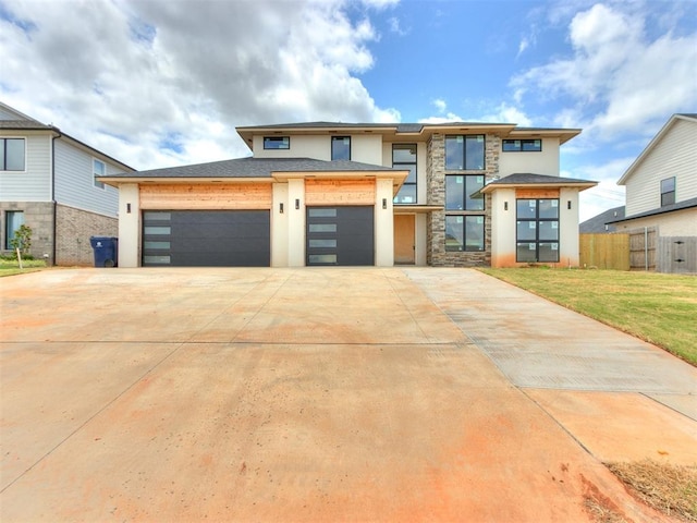 prairie-style home with a garage and a front lawn