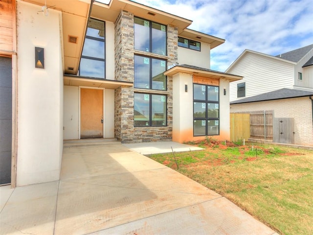 property entrance with a yard and a patio area