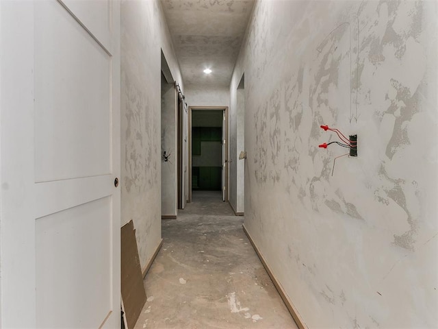 hall featuring concrete flooring