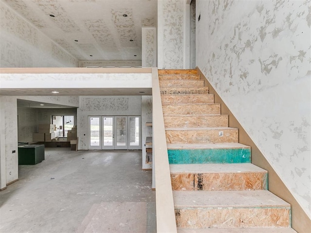 stairs featuring concrete flooring