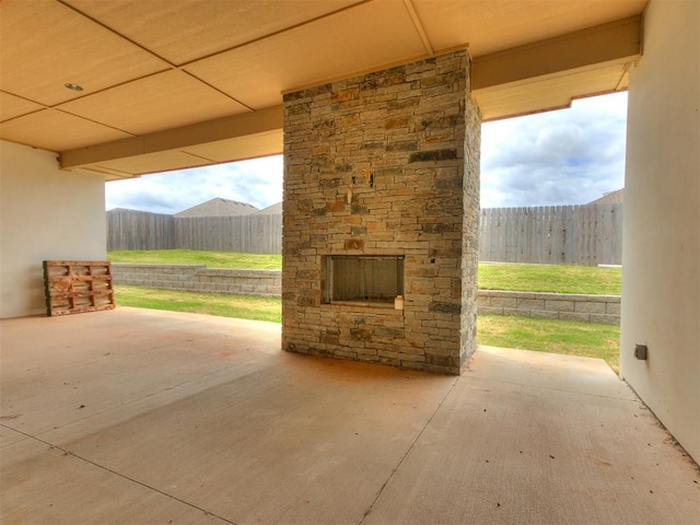 view of patio with an outdoor stone fireplace