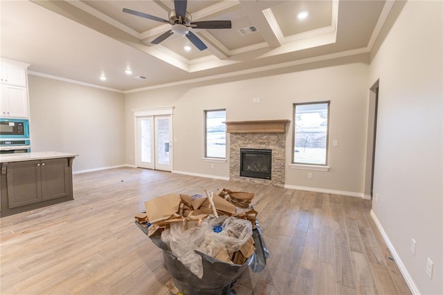 living room with light wood-type flooring, crown molding, and coffered ceiling