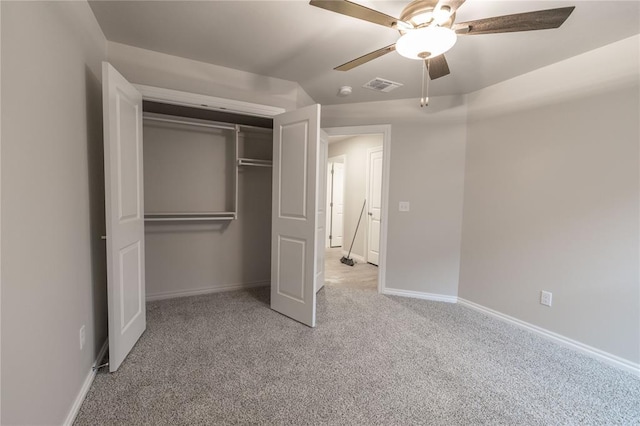 unfurnished bedroom featuring a closet, ceiling fan, and light colored carpet