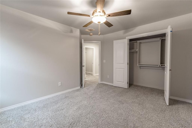 unfurnished bedroom with light carpet, a closet, and ceiling fan