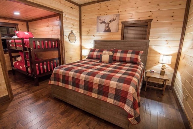 bedroom featuring wooden ceiling, dark hardwood / wood-style flooring, and wood walls