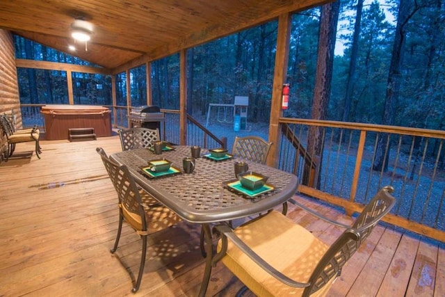 wooden deck with a hot tub and a grill