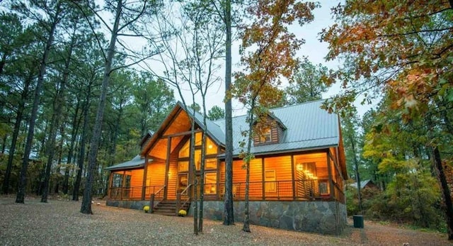 rear view of property with covered porch