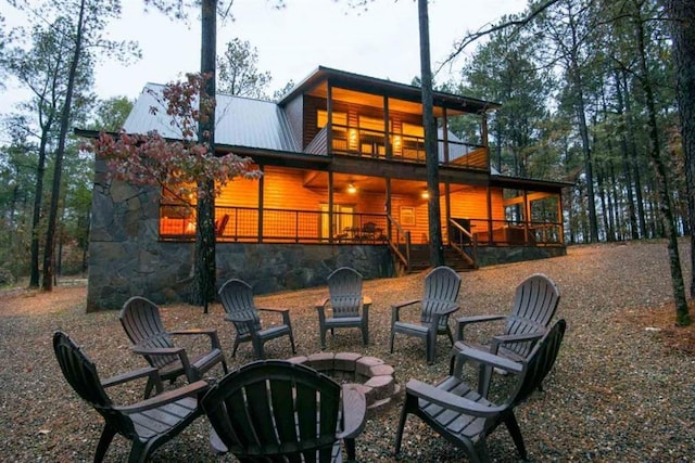 back of property with an outdoor fire pit