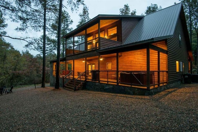 back of house featuring a balcony