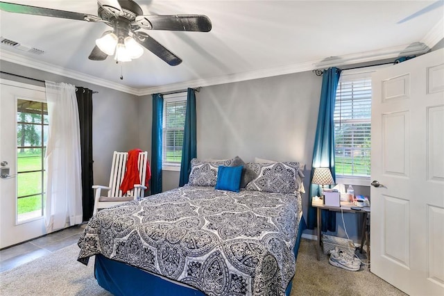 carpeted bedroom featuring multiple windows, ceiling fan, and crown molding