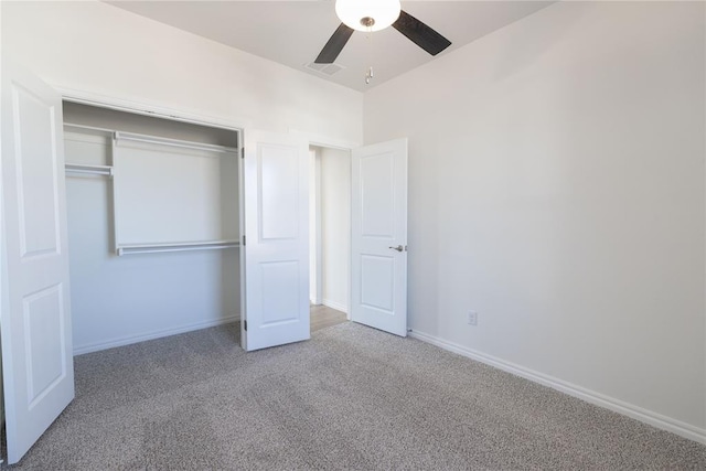 unfurnished bedroom with carpet, ceiling fan, and a closet