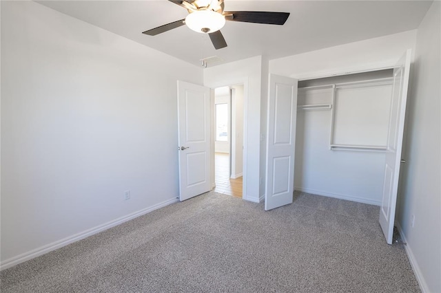 unfurnished bedroom with ceiling fan, carpet flooring, and a closet