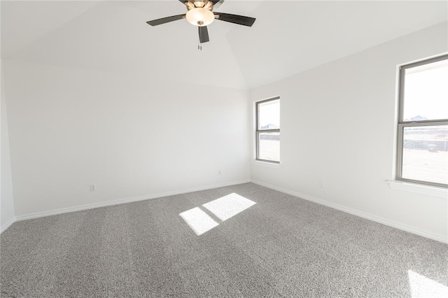 spare room featuring ceiling fan, lofted ceiling, and carpet