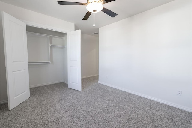 unfurnished bedroom with carpet floors, ceiling fan, and a closet