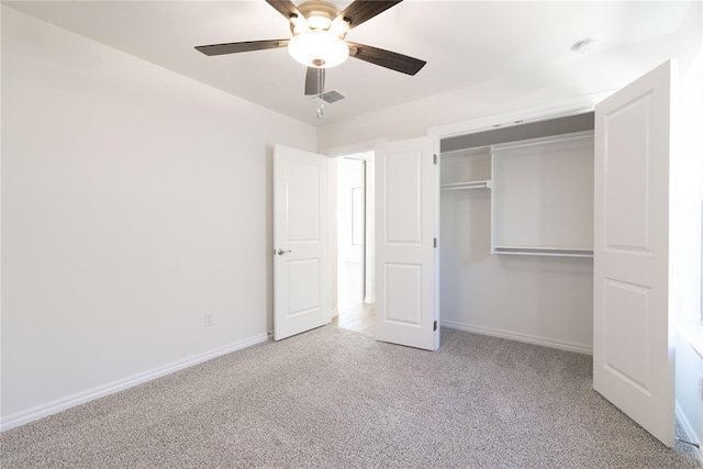 unfurnished bedroom with ceiling fan, light carpet, and a closet