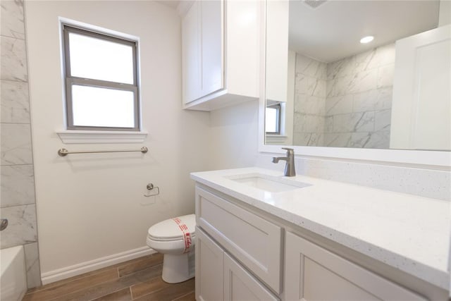 full bathroom featuring vanity, bathing tub / shower combination, and toilet