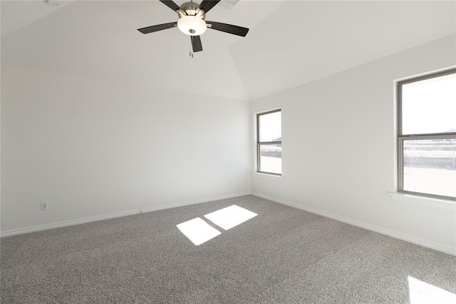 spare room featuring lofted ceiling, carpet floors, and ceiling fan