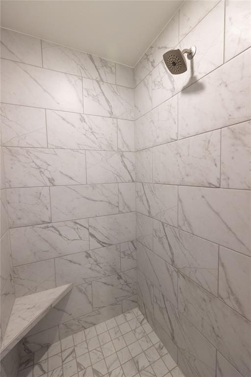 bathroom with a tile shower