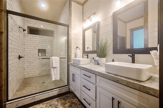 bathroom featuring vanity and an enclosed shower