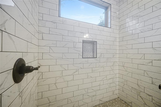 bathroom with tiled shower