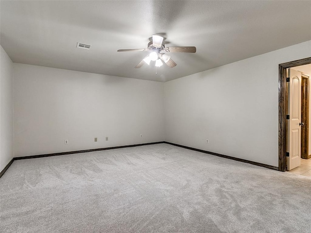 carpeted empty room featuring ceiling fan