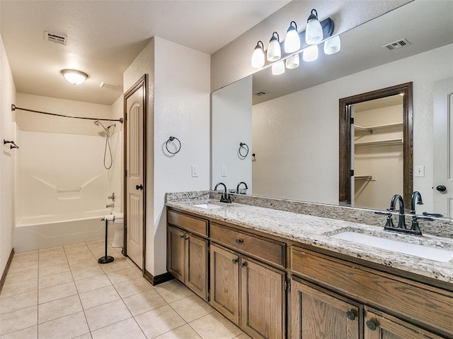 bathroom featuring tile patterned flooring, vanity, and tub / shower combination