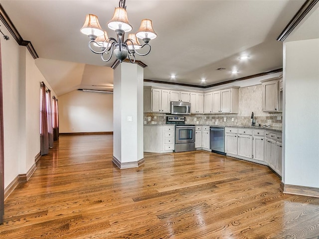 kitchen featuring pendant lighting, white cabinets, light hardwood / wood-style flooring, appliances with stainless steel finishes, and a chandelier