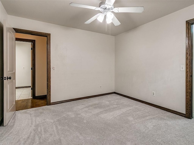 spare room with light carpet and ceiling fan