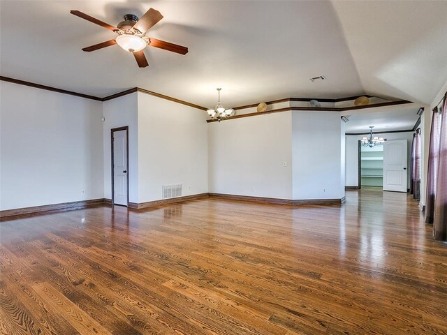 9500 S Brookline Ave, Oklahoma City, OK 73159 - empty room with wood finished floors, visible vents, baseboards, and ceiling fan with notable chandelier