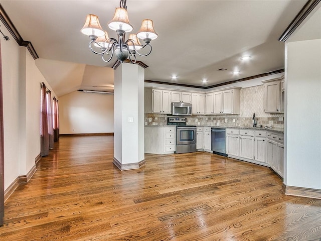 9500 S Brookline Ave, Oklahoma City, OK 73159 - kitchen featuring backsplash, light wood finished floors, appliances with stainless steel finishes, and a notable chandelier