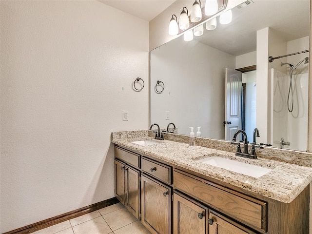 9500 S Brookline Ave, Oklahoma City, OK 73159 - full bathroom with double vanity, tile patterned flooring, baseboards, and a sink