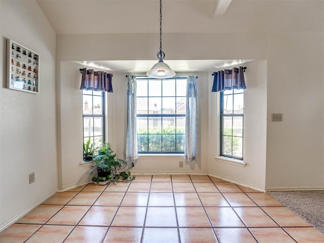 unfurnished dining area with light tile patterned flooring and a healthy amount of sunlight