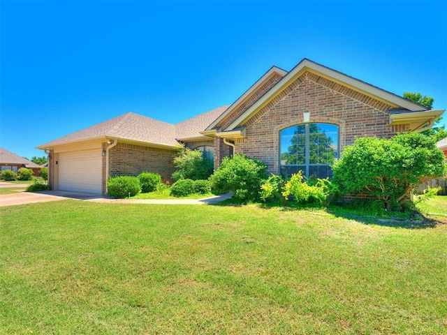 view of front of house with a garage and a front yard