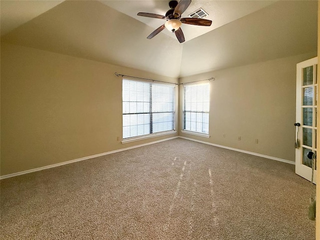 empty room with ceiling fan, carpet flooring, and vaulted ceiling