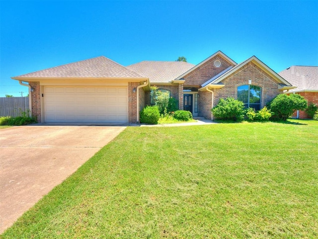 ranch-style home with a garage and a front yard