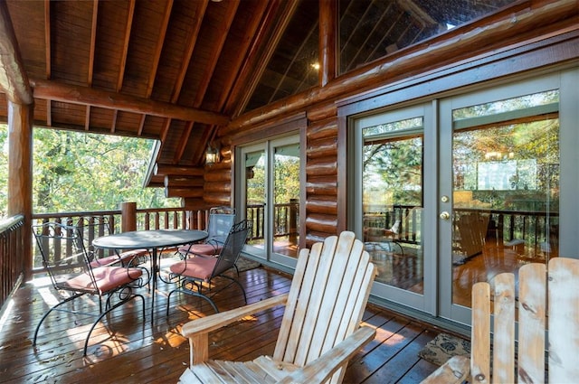 sunroom / solarium with a healthy amount of sunlight, lofted ceiling with beams, and wooden ceiling