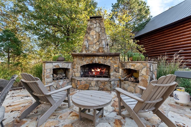 view of patio / terrace with an outdoor stone fireplace