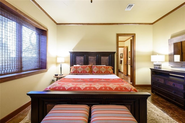 bedroom with dark hardwood / wood-style flooring and ornamental molding