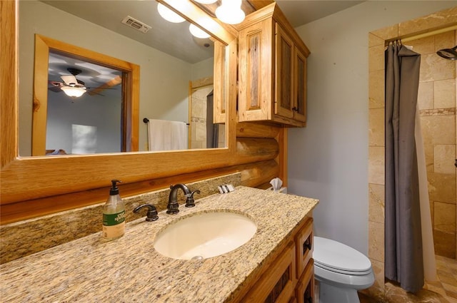 bathroom featuring a shower with curtain, ceiling fan, toilet, and vanity