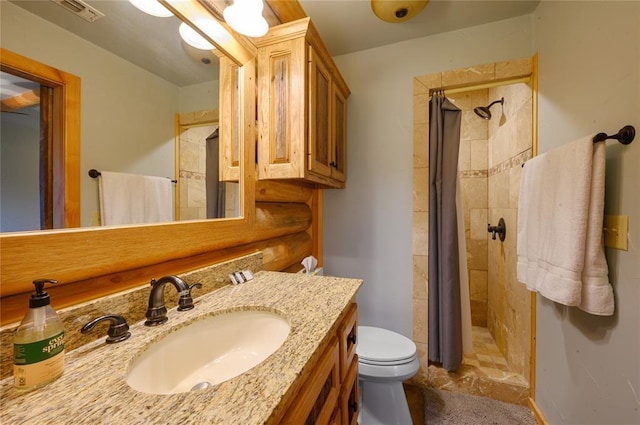 bathroom featuring vanity, toilet, and walk in shower