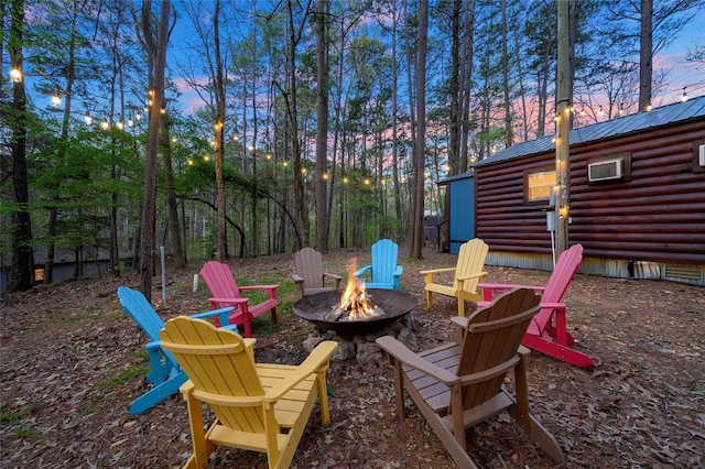 patio terrace at dusk featuring an outdoor fire pit