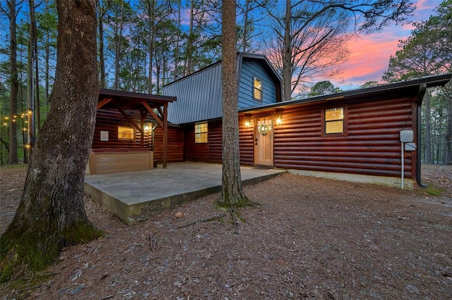 back house at dusk with a patio