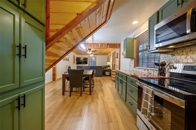 kitchen featuring green cabinetry, stainless steel appliances, and light hardwood / wood-style flooring