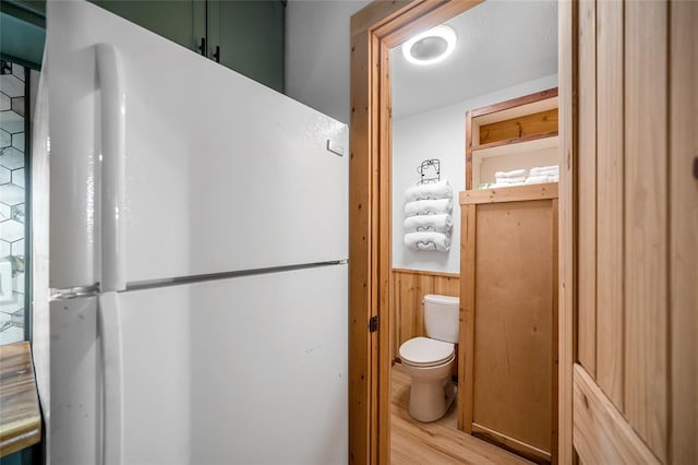 bathroom featuring toilet and hardwood / wood-style flooring