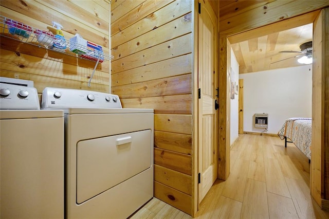 laundry room with washer and clothes dryer, ceiling fan, wooden walls, and light hardwood / wood-style flooring