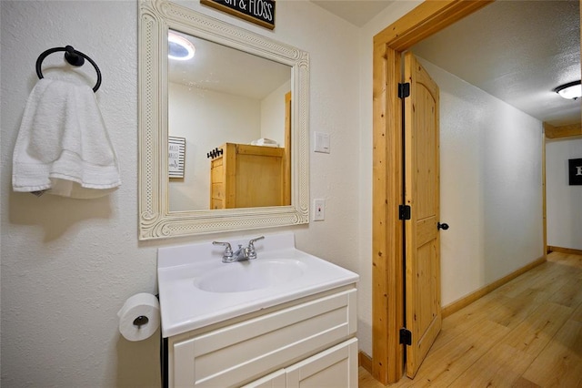 bathroom featuring wood-type flooring and vanity