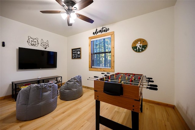 playroom with ceiling fan and hardwood / wood-style floors