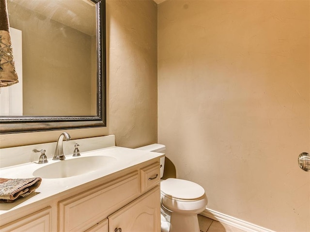 bathroom with tile patterned floors, vanity, and toilet