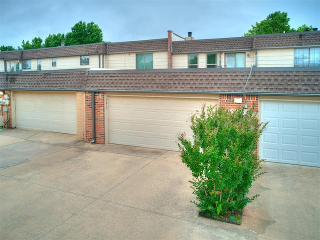 multi unit property featuring a garage