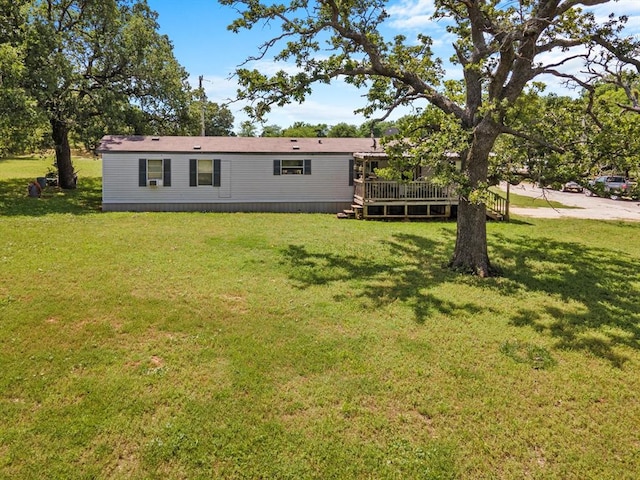 view of front facade featuring a deck and a front yard